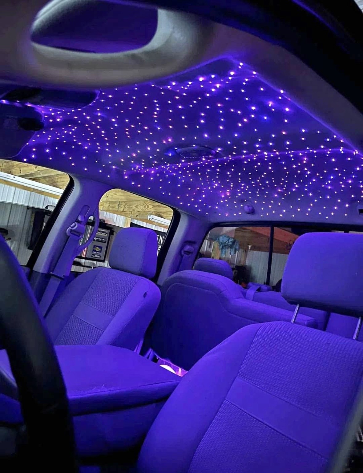 Purple fiber-optic starlight headliner installed in a truck cab