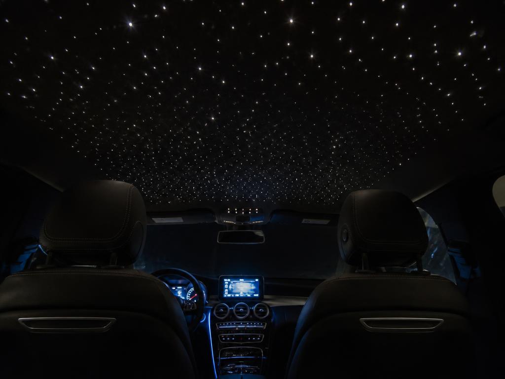 Night view of a car interior with a white fiber-optic star ceiling